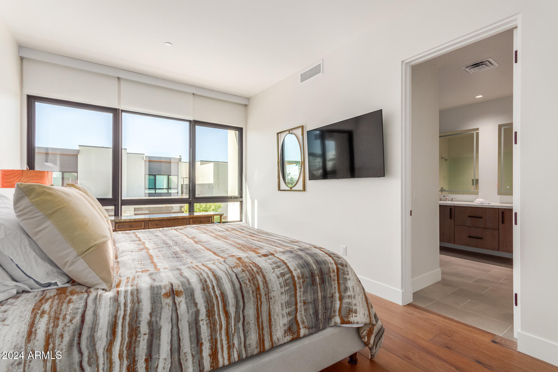 6311 East Phoenician Boulevard, Unit 18 Scottsdale, AZ 85251 - Photo 23 of 45 a bedroom with a bed and a television