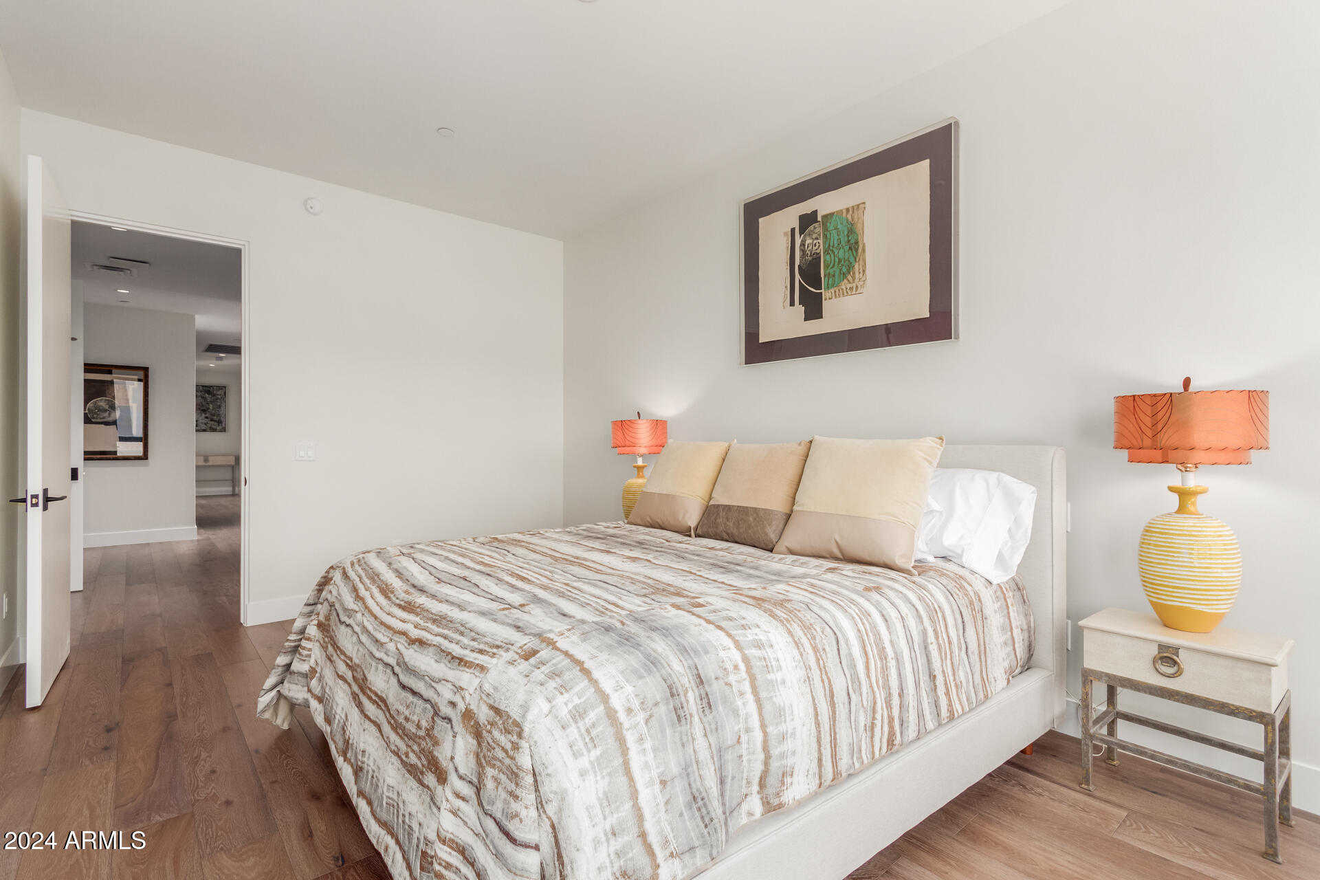 6311 East Phoenician Boulevard, Unit 18 Scottsdale, AZ 85251 - Photo 24 of 45 a bedroom with a bed and wooden floor