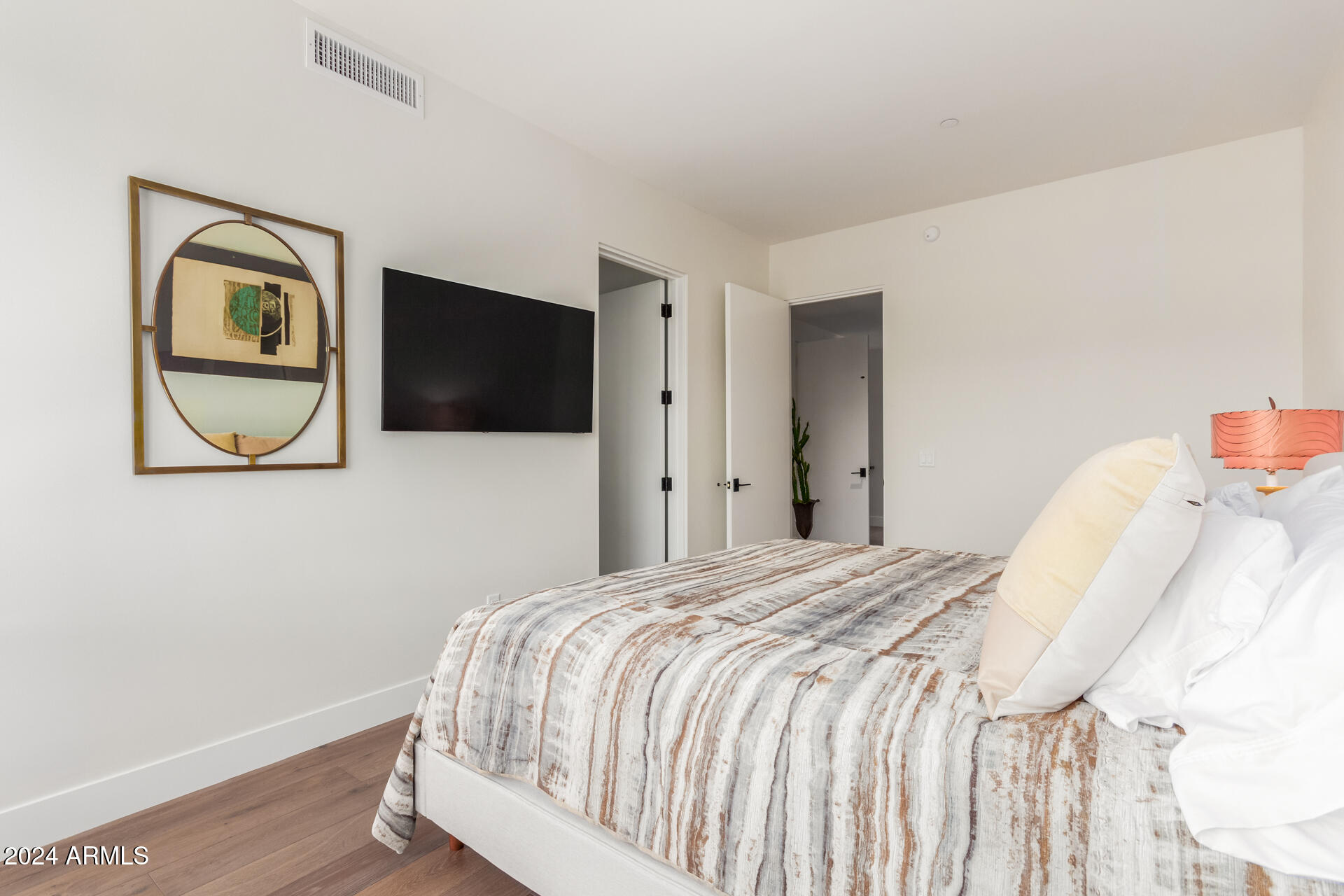 6311 East Phoenician Boulevard, Unit 18 Scottsdale, AZ 85251 - Photo 25 of 45 a bedroom with a bed and a flat screen tv