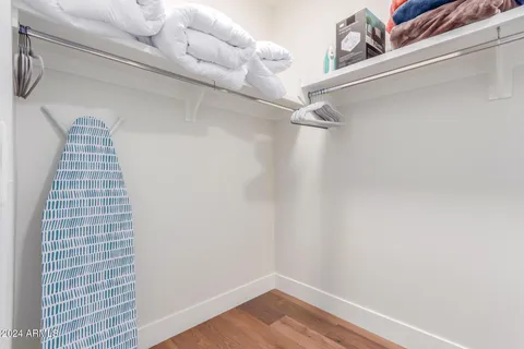 a bedroom with a bed and a night stand