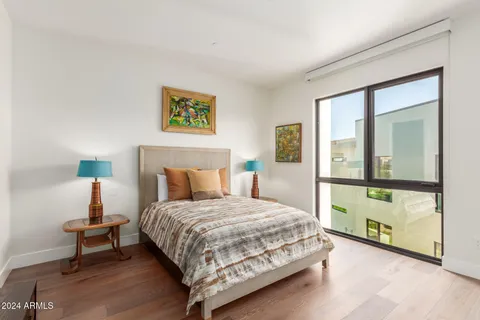 a bedroom with a bed and a night stand