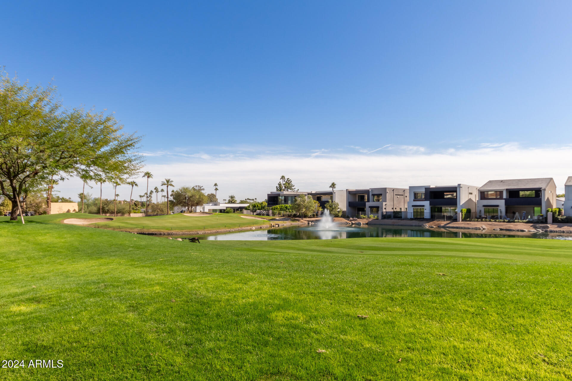 6311 East Phoenician Boulevard, Unit 18 Scottsdale, AZ 85251 - Photo 44 of 45 a view of a building and a yard with swimming pool