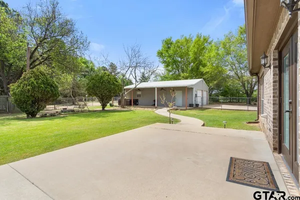 an empty room with wooden floor and ceiling fan