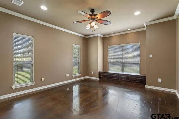 a view of a livingroom with furniture hardwood floor and a ceiling fan