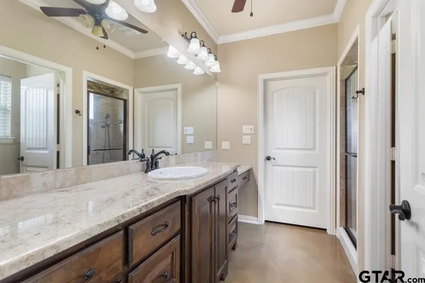 a view of a hallway with wooden floor and a chandelier