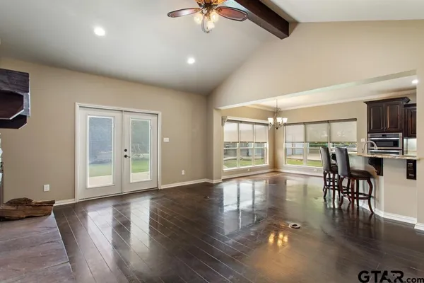 a kitchen with granite countertop a sink stainless steel appliances and cabinets