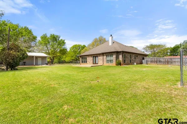 a view of house with outdoor space and garden