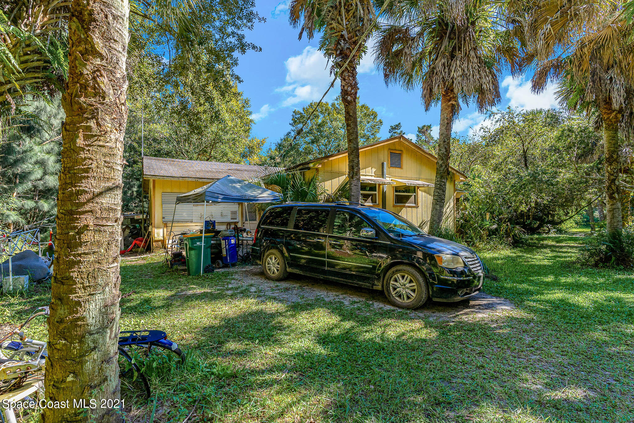 1717 Jones Road Melbourne, FL 32934 - Photo 2 of 20 a car parked in front of a house with a big yard
