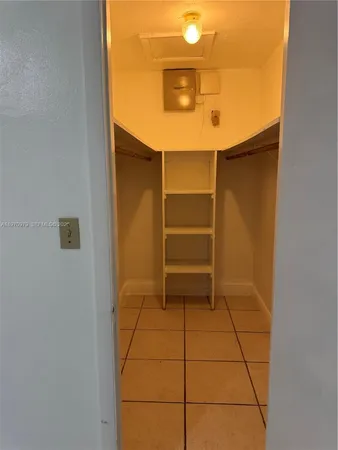 an empty room with a fan and a window