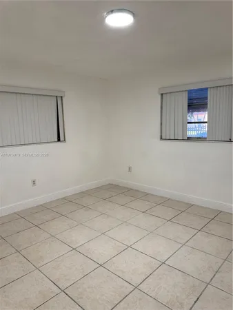 a bathroom with a sink a toilet a mirror and shower