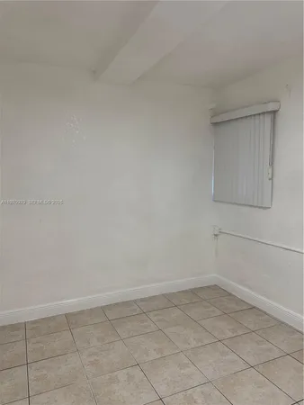 a kitchen with a refrigerator and cabinets