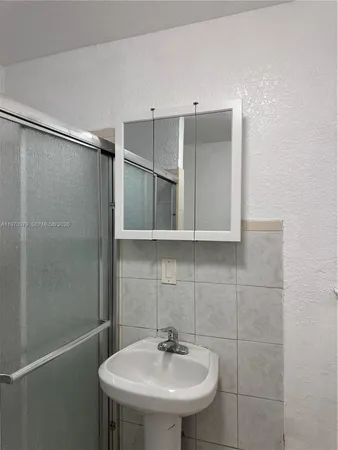a metallic refrigerator freezer sitting in a kitchen