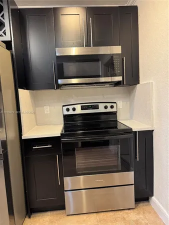 a kitchen with a sink cabinets and a window