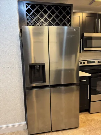 a view of kitchen with refrigerator and a sink
