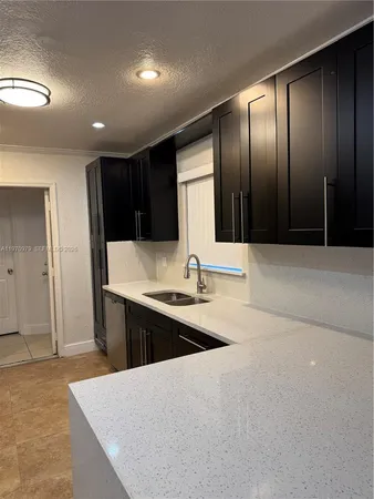 a kitchen with a sink and cabinets