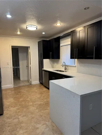 a kitchen with stainless steel appliances a refrigerator and a sink
