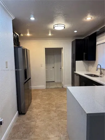 a view of a patio with a table and chairs under an umbrella