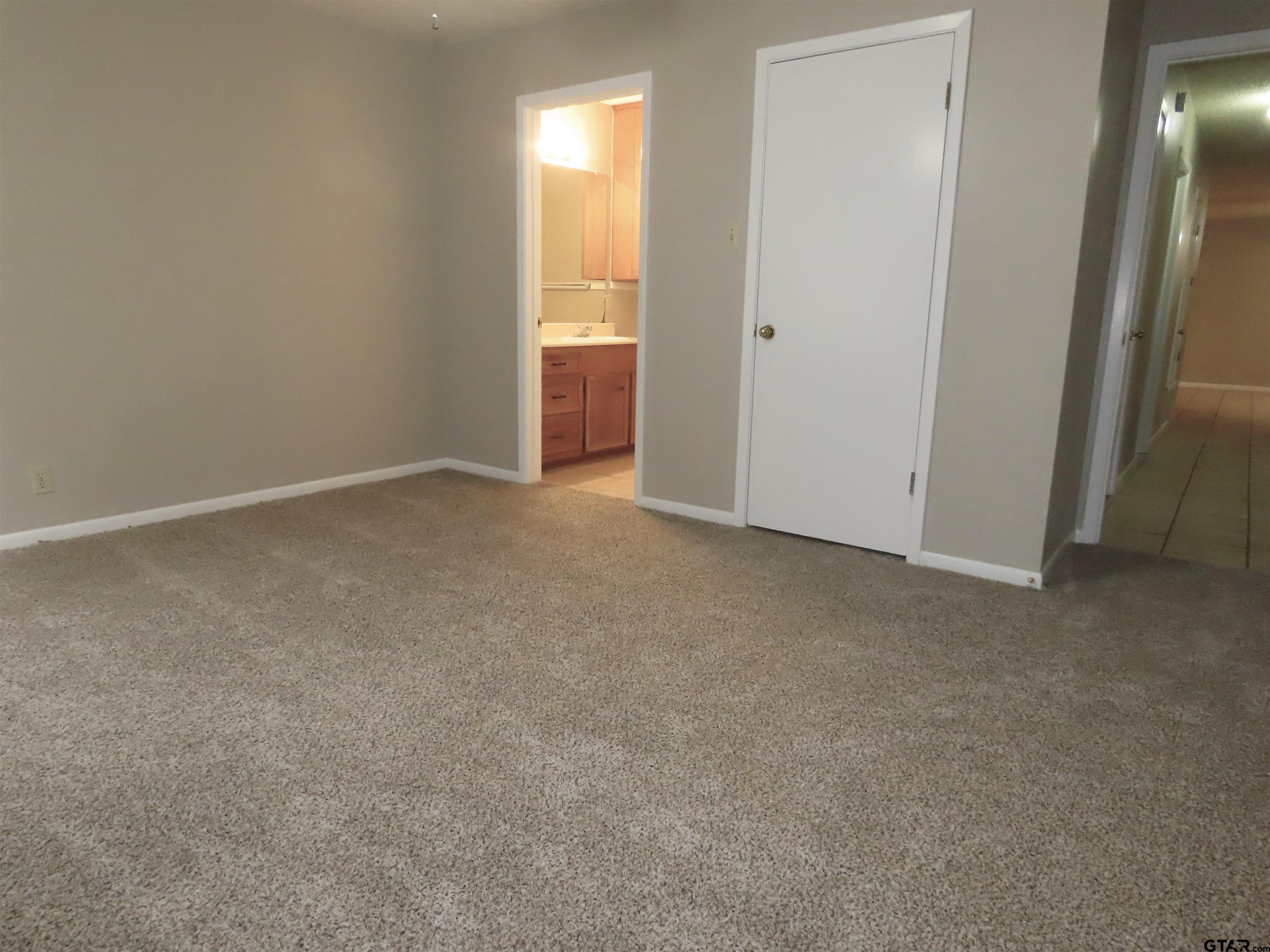 402 Muller Garden Road Tyler, TX 75703 - Photo 25 of 33 an empty room with windows and closet