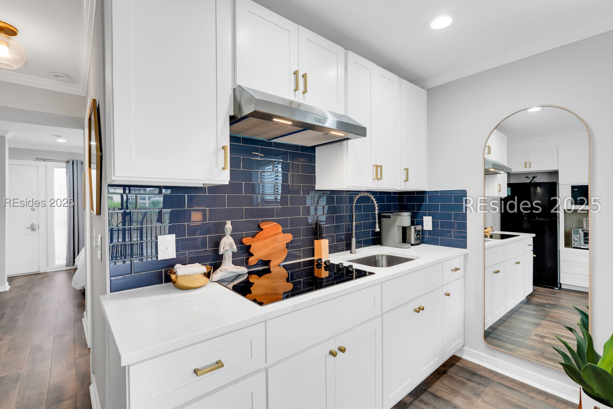 40 Folly Field Road, Unit A1 Hilton Head Island, SC 29928 - Photo 14 of 42 Navy blue subway tiles, and electric cooktop.