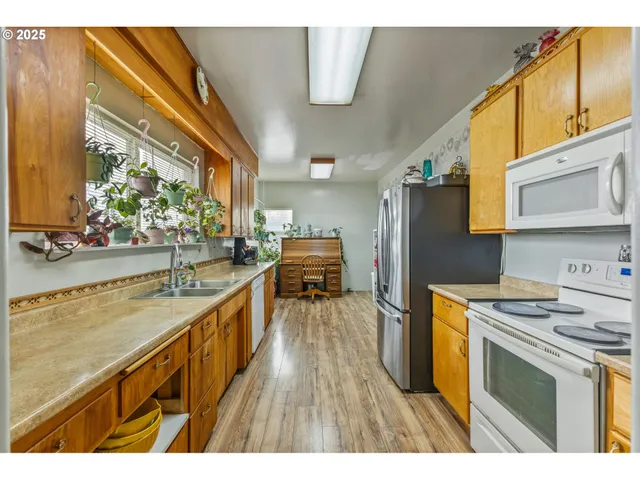 a kitchen with a sink stove and refrigerator