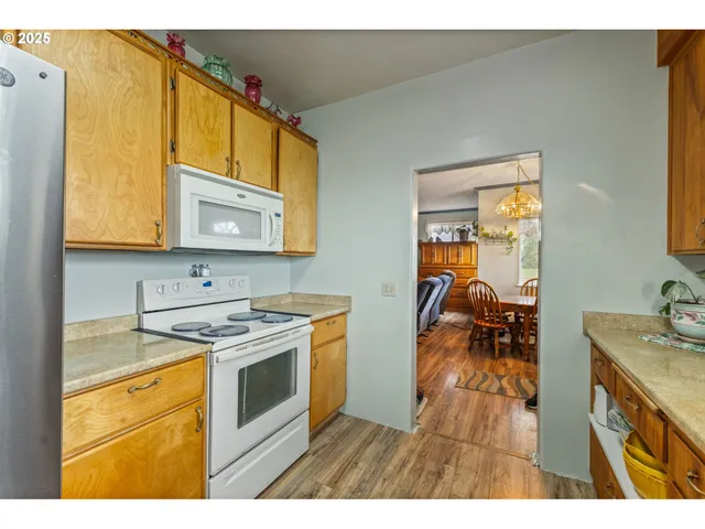 a kitchen with a stove a sink and a microwave