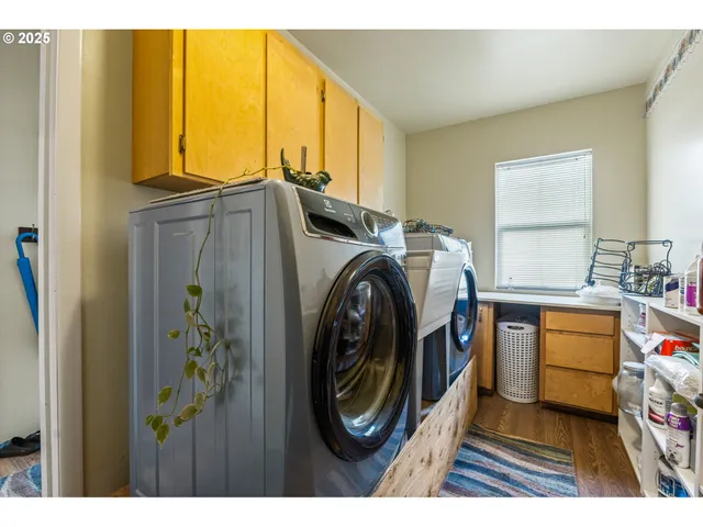 a utility room with sink dryer and washer