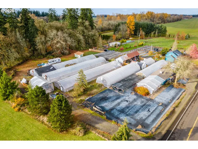 an aerial view of a house with a garden and swimming pool