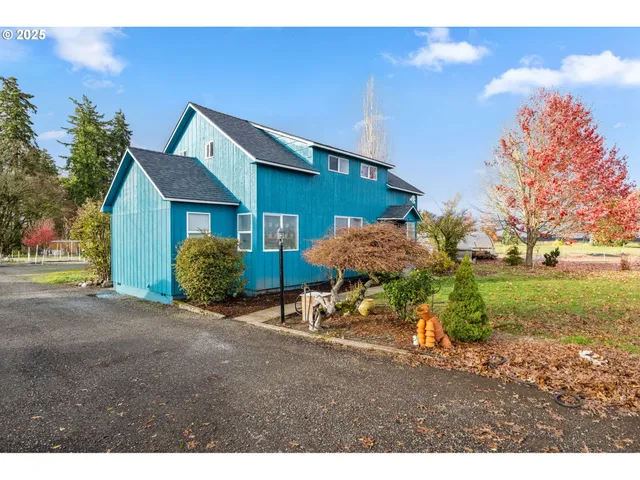a backyard of a house with table and chairs