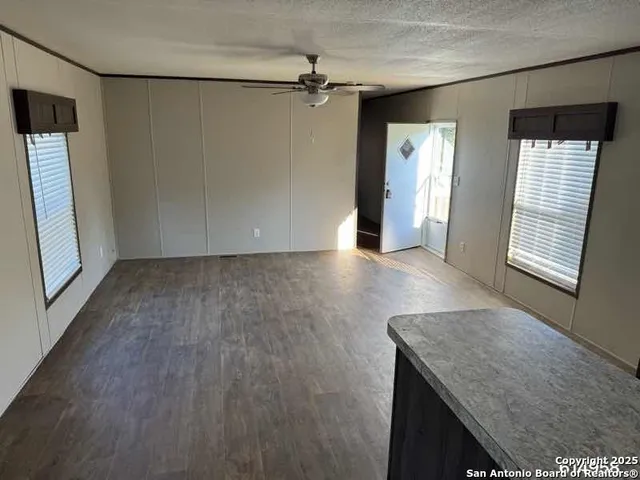 an empty room with windows and entrance