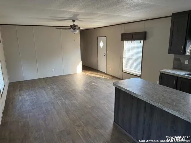 a view of a kitchen cabinets and wooden floor