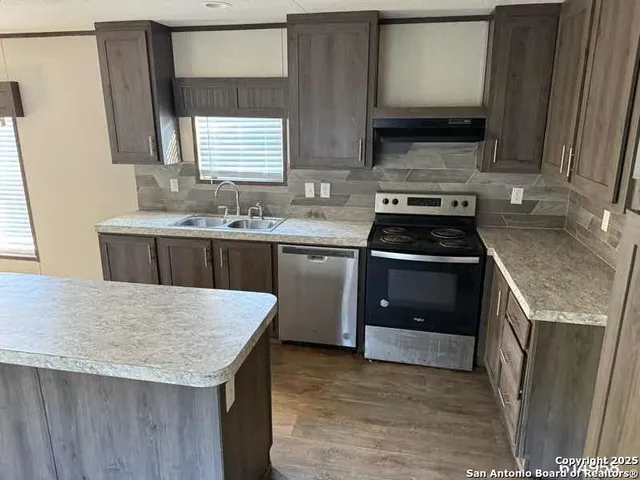 a kitchen with a stove and a sink