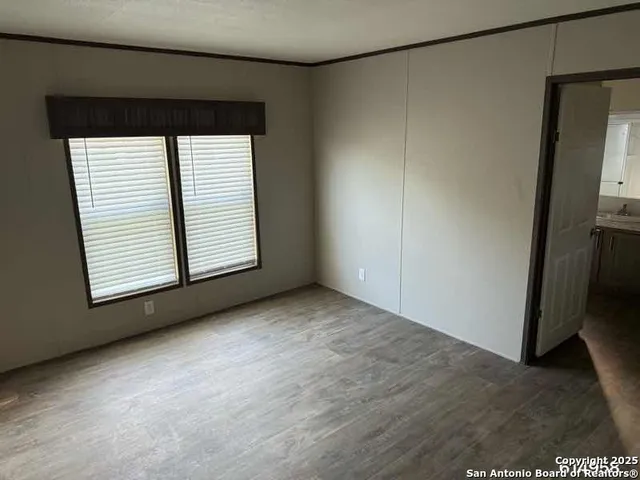an empty room with windows and closet