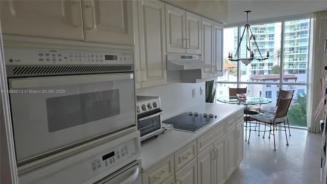 a kitchen with appliances cabinets and wooden floor