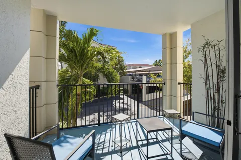 a view of a balcony with chairs