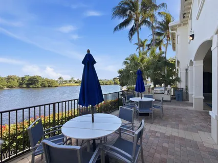 an aerial view of residential houses with outdoor space and lake view