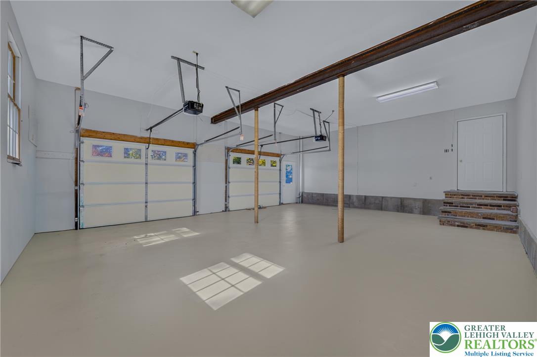 630 Clearfield Road Nazareth, PA 18064 - Photo 86 of 100 An expansive multi-vehicle garage with smooth poured concrete flooring and direct interior entry.
