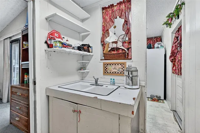 a living room with furniture a ceiling fan and a large window