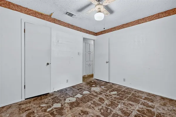 a view of a room with a window and ceiling fan