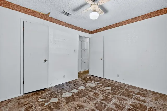 a view of a room with a window and ceiling fan