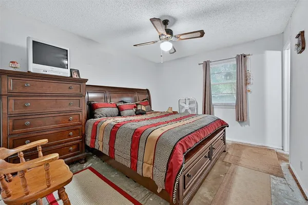 a view of a room with a ceiling fan and wooden floor