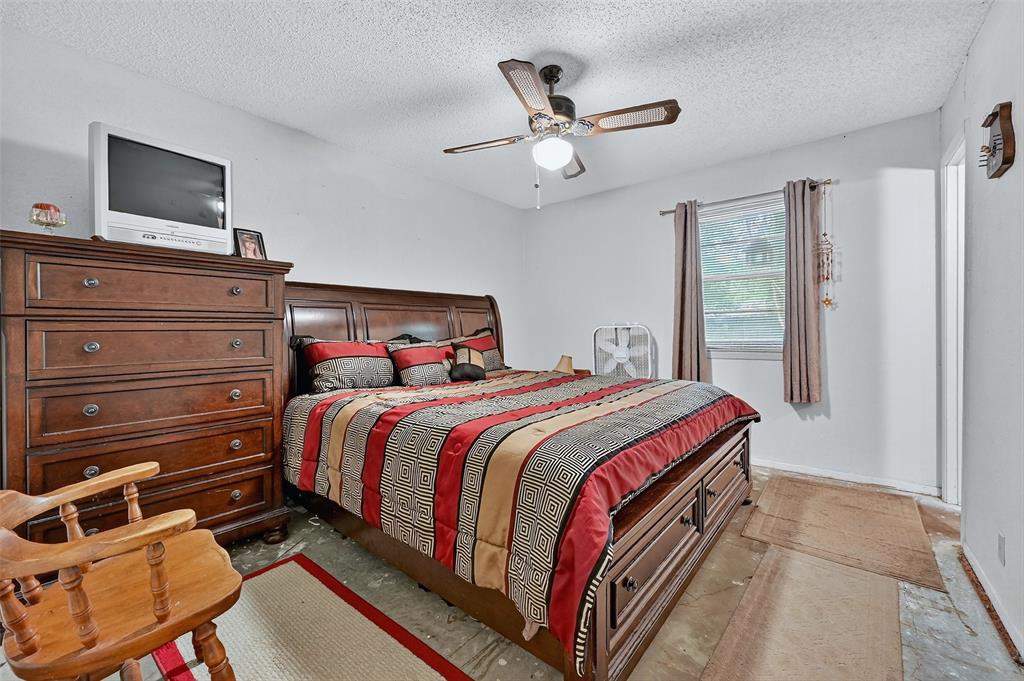 164 Ash Denison, TX 75020 - Photo 19 of 29 a bedroom with a bed and a flat screen tv