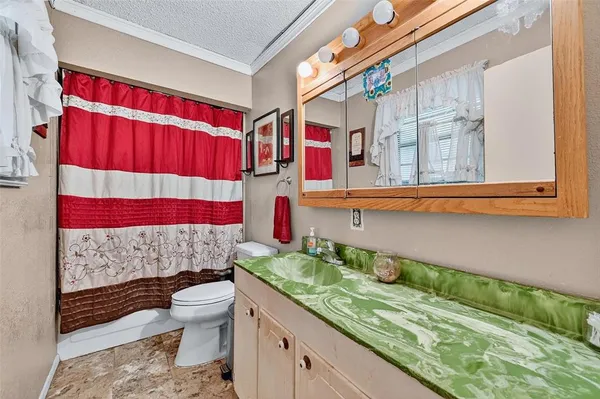 a bedroom with bed and a chandelier