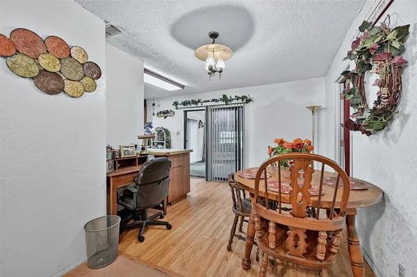 a view of a dining room with furniture and chandelier