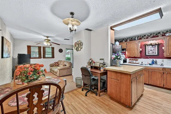 a view of a chair and table in backyard of the house