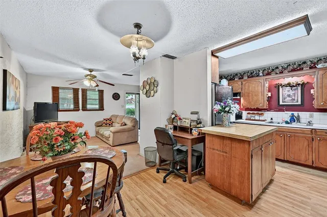 a view of a chair and table in backyard of the house