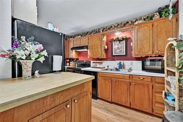 a view of a kitchen area with furniture and wooden floor