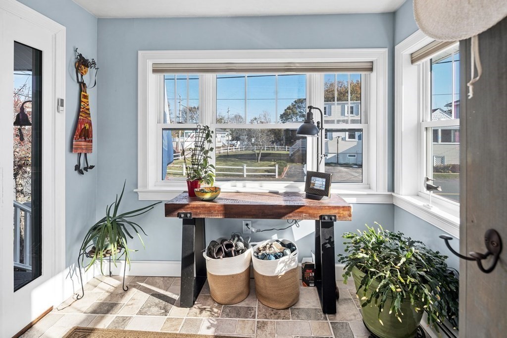 103 Newport Road Hull, MA 02045 - Photo 3 of 40 a dining room filled with furniture and a potted plant