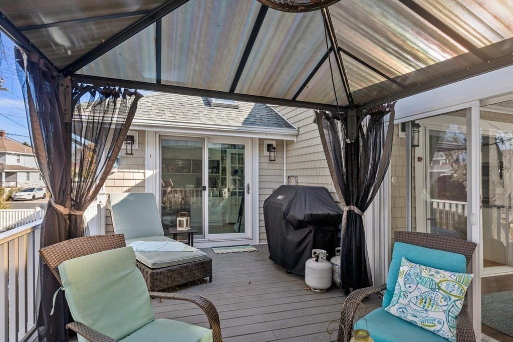 103 Newport Road Hull, MA 02045 - Photo 33 of 40 a living room with furniture a fireplace and a floor to ceiling window