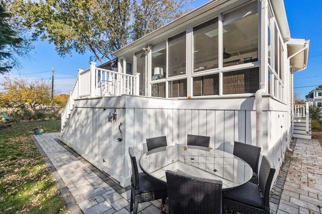 103 Newport Road Hull, MA 02045 - Photo 34 of 40 a view of a patio with table and chairs with wooden floor and fence