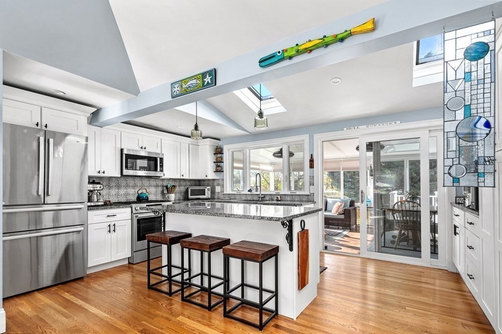 103 Newport Road Hull, MA 02045 - Photo 10 of 40 a large kitchen with a table and chairs in it